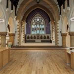 Image shows the inside of a church, looking towards the altar
